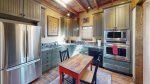 Bright kitchen stocked with cooking and dining appliances 